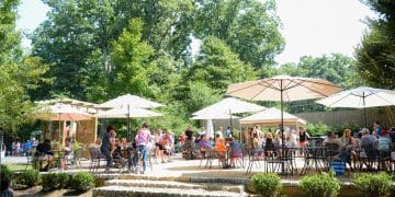 People gather on the patio as part of their wine tour at Keswick Vineyards